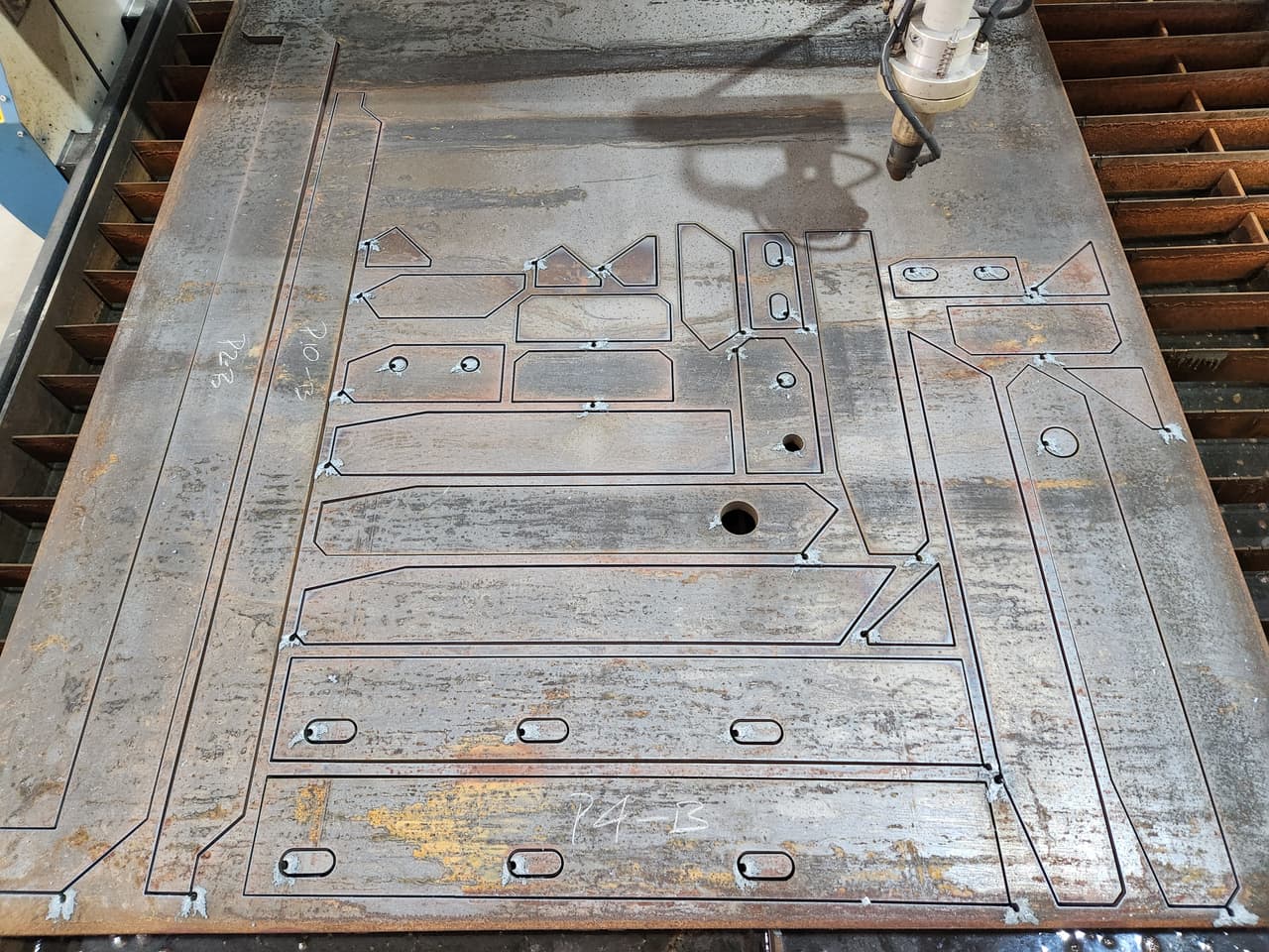 Profile-cut steel plate with cut-out shapes for fabricated parts